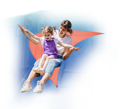 A woman and little girl ride a playground slide. A salmon-colored liver shape appears behind them.
