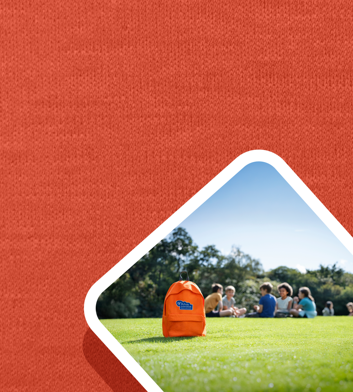 FAQs. Picture of an orange BYLVAYbackpack lying in the grass.