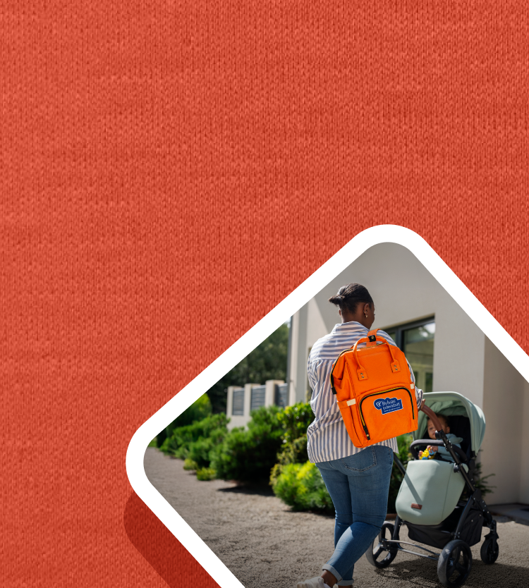 Picture of a woman wearing the orange BYLVAY backpack and pushing a stroller.
